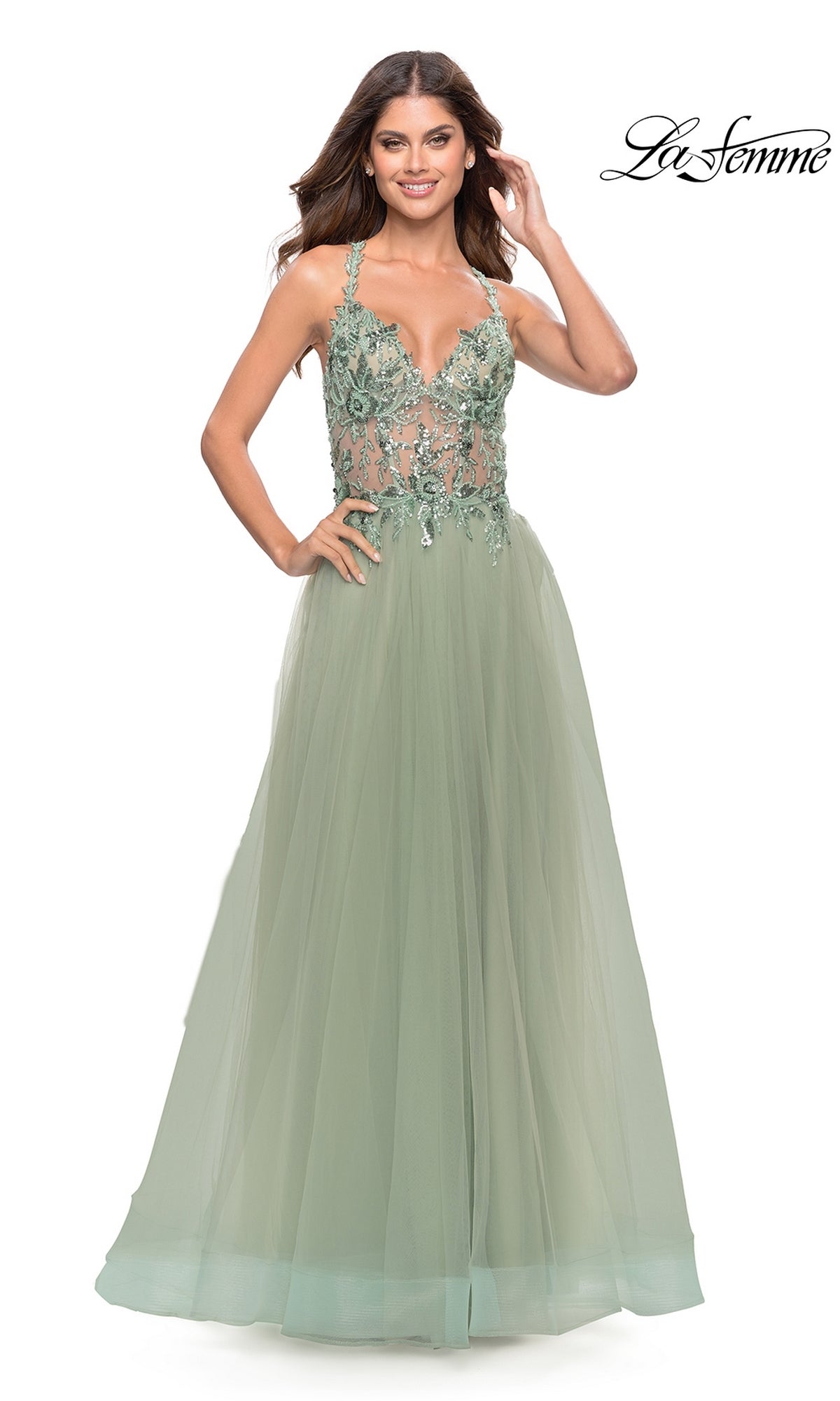 A woman poses against a white background in the La Femme Lace-Bodice Long Prom Dress 31369, a light green A-line gown with floral embroidery and an embellished lace bodice. The